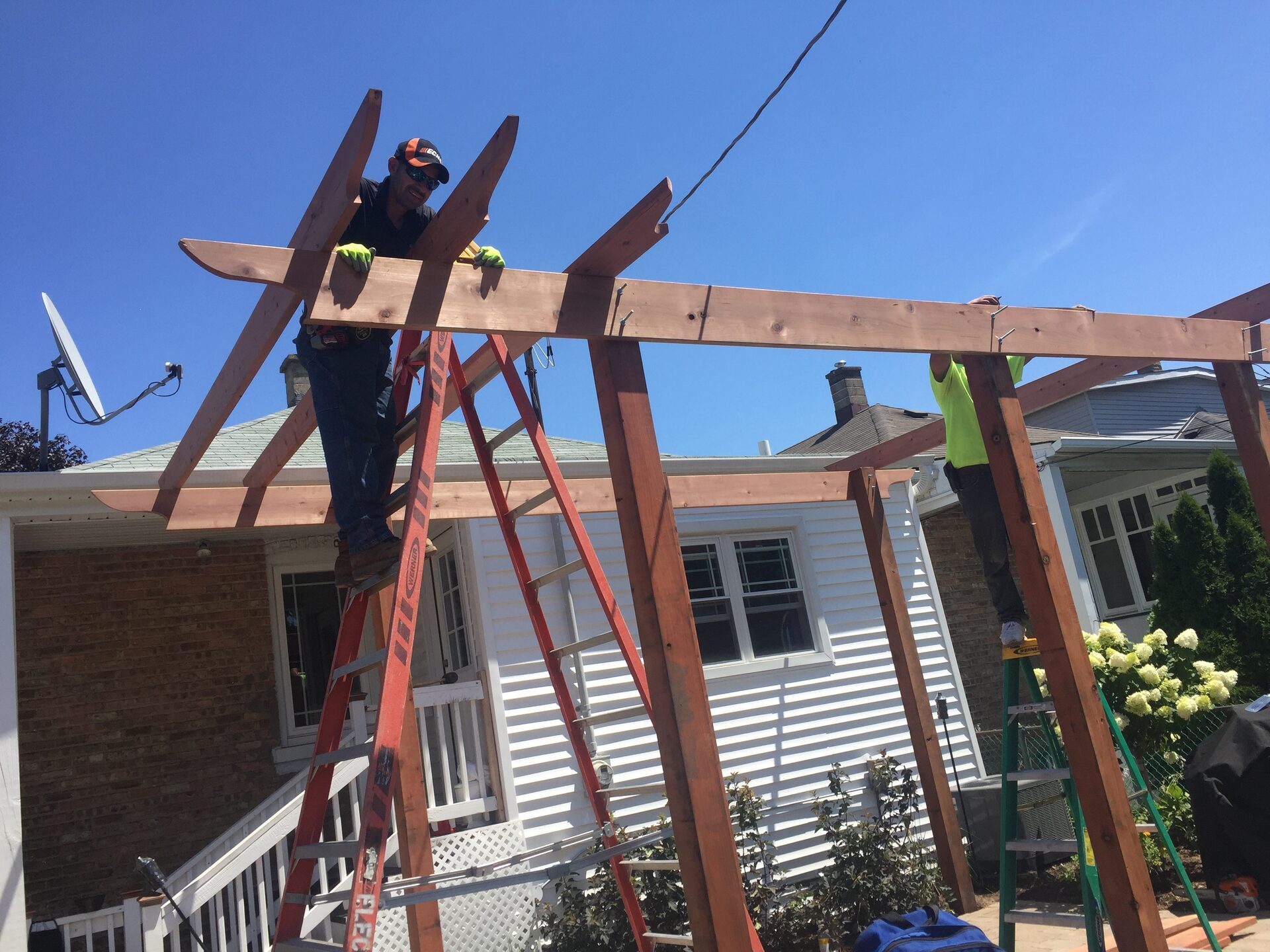 Crew building cedar pergola frame