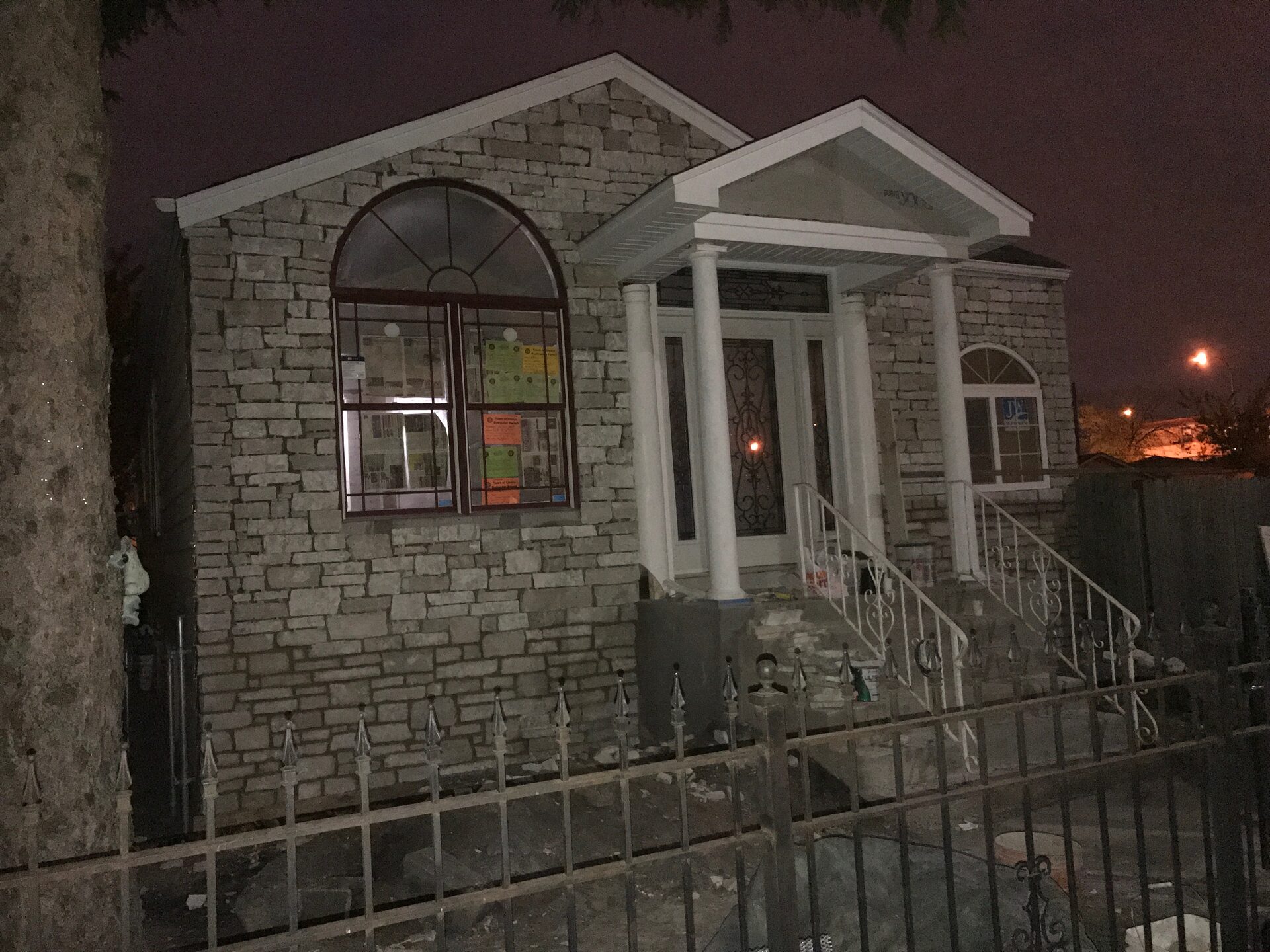 Stone veneer building exterior with arched windows