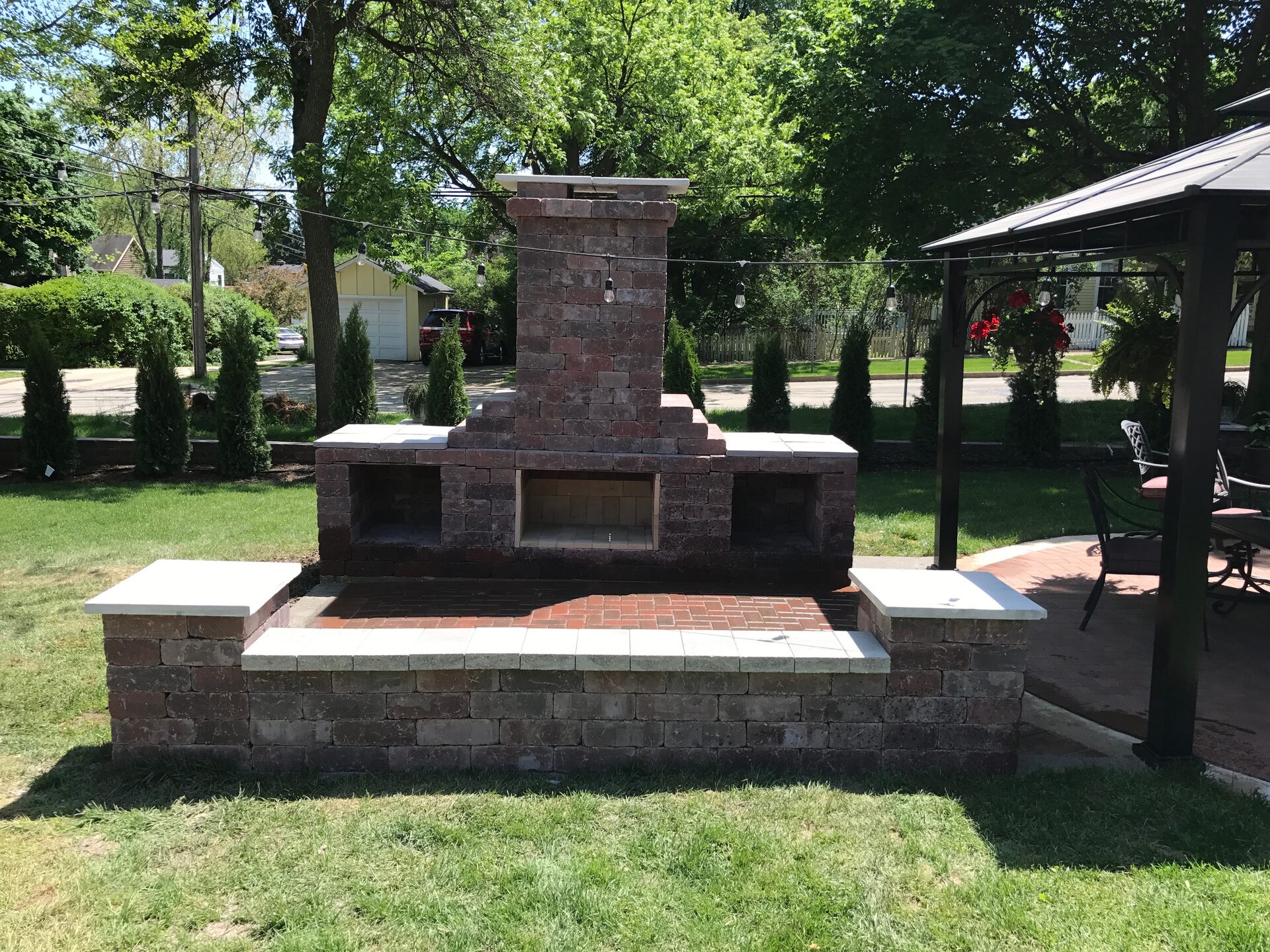 Outdoor brick fireplace with seating walls